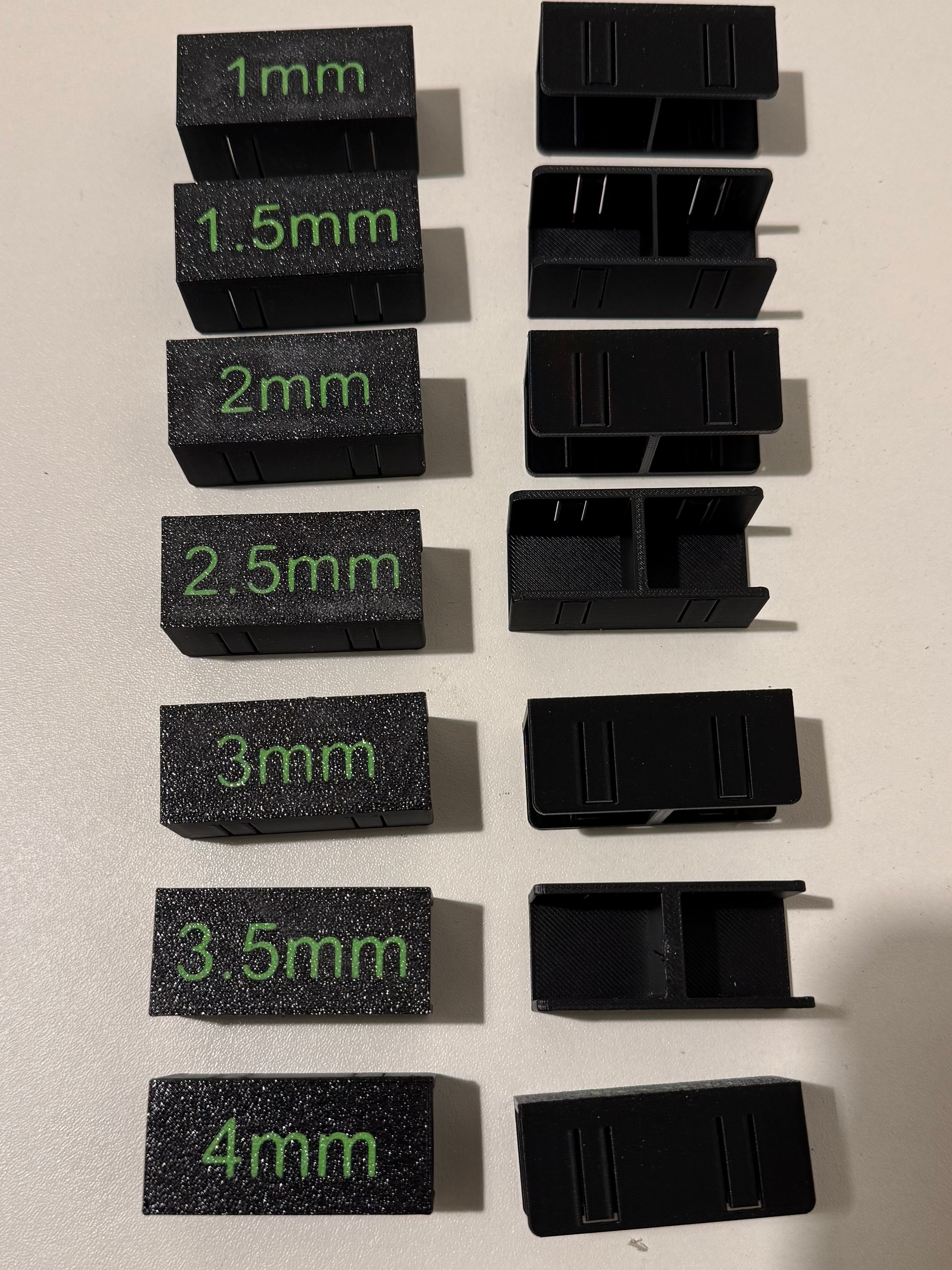 Set of black measurement blocks with green measurements on a beige surface